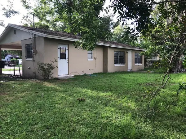 a front view of house with yard and trees
