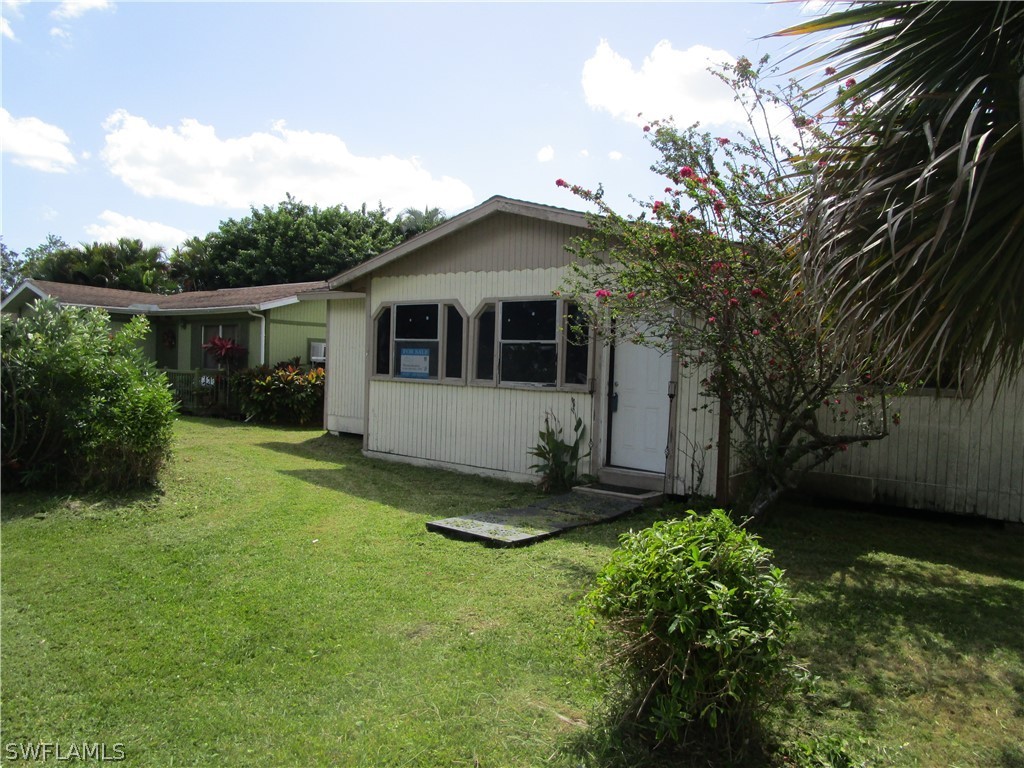 a front view of house with yard and green space