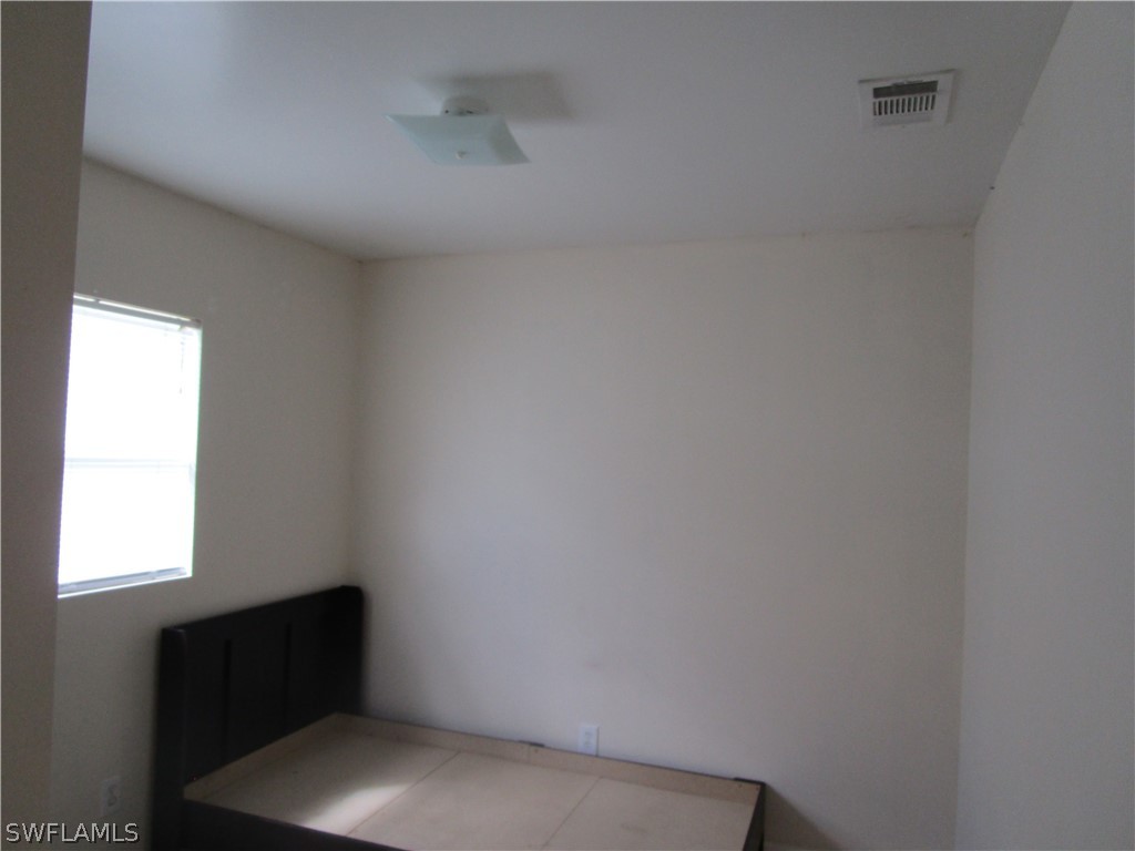 15790 Pine Ridge Road Fort Myers, FL 33908 - Photo 14 of 17 a view of an empty room with a window