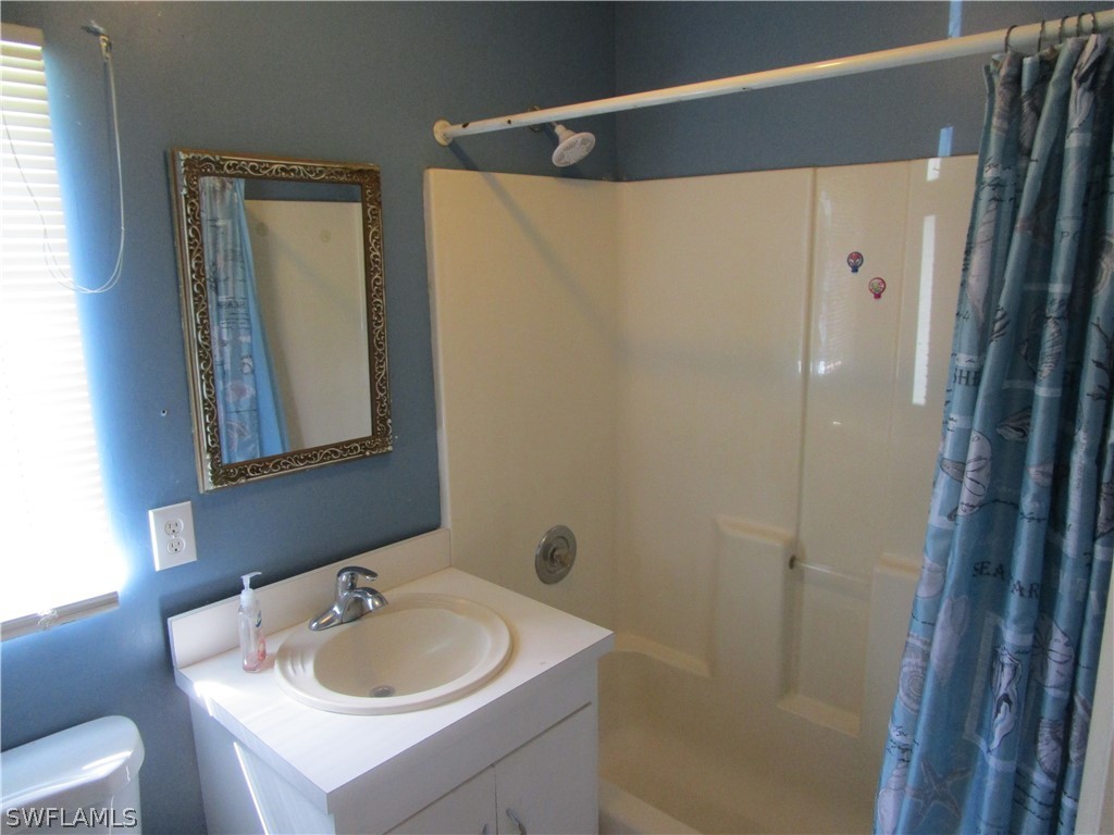 15790 Pine Ridge Road Fort Myers, FL 33908 - Photo 17 of 17 a bathroom with a sink toilet and shower