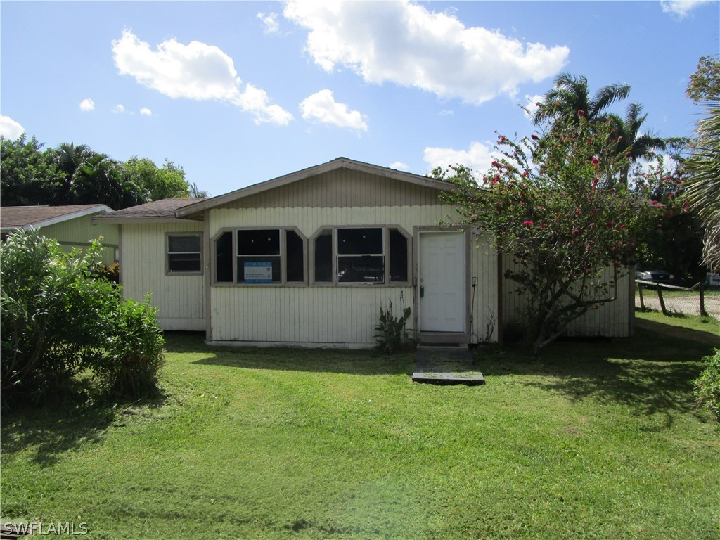 15790 Pine Ridge Road Fort Myers, FL 33908 - Photo 2 of 17 a front view of a house with a garden