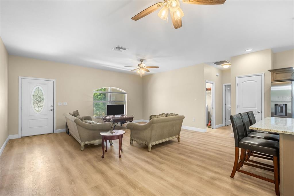 13391 Ruffed Grouse Road Weeki Wachee, FL 34614 - Photo 11 of 25 a living room with furniture and a wooden floor