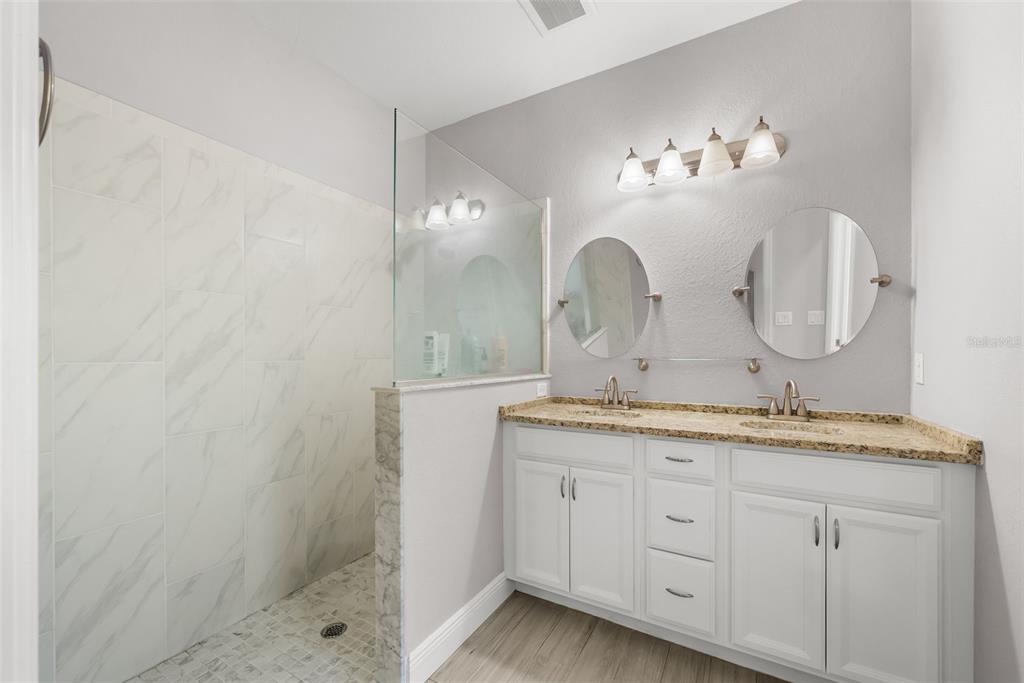 13391 Ruffed Grouse Road Weeki Wachee, FL 34614 - Photo 14 of 25 a bathroom with a double vanity sink and a mirror