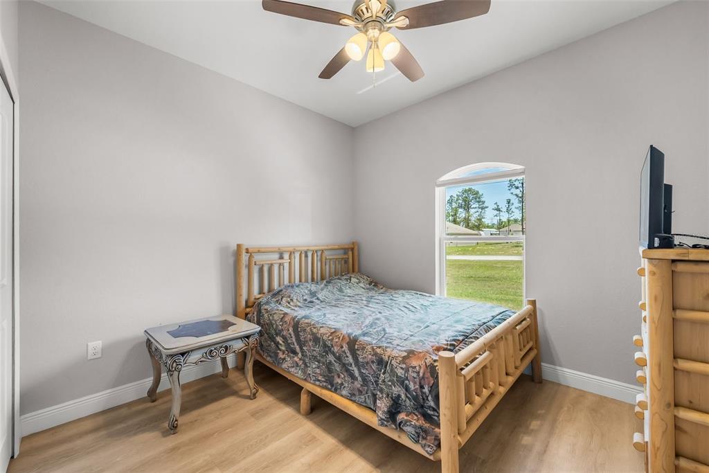 13391 Ruffed Grouse Road Weeki Wachee, FL 34614 - Photo 15 of 25 a bed room with a bed and a window