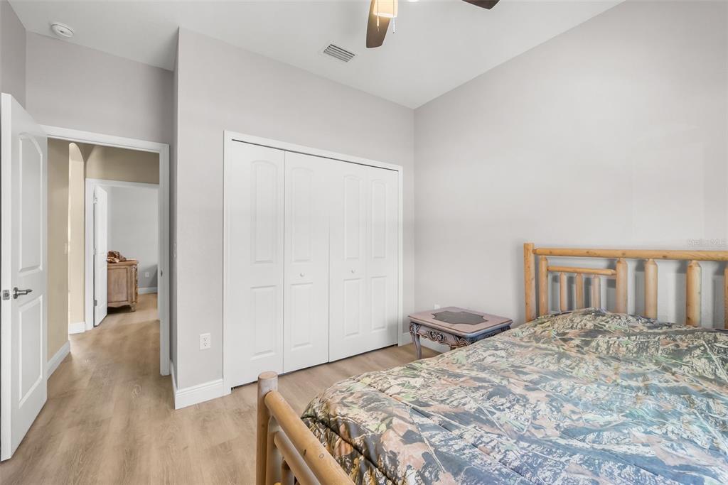 13391 Ruffed Grouse Road Weeki Wachee, FL 34614 - Photo 16 of 25 a bedroom with a bed and a cabinets