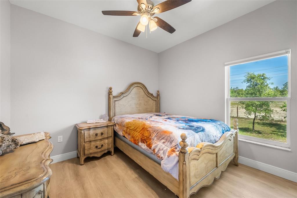 13391 Ruffed Grouse Road Weeki Wachee, FL 34614 - Photo 17 of 25 a bed sitting in a bedroom next to a window