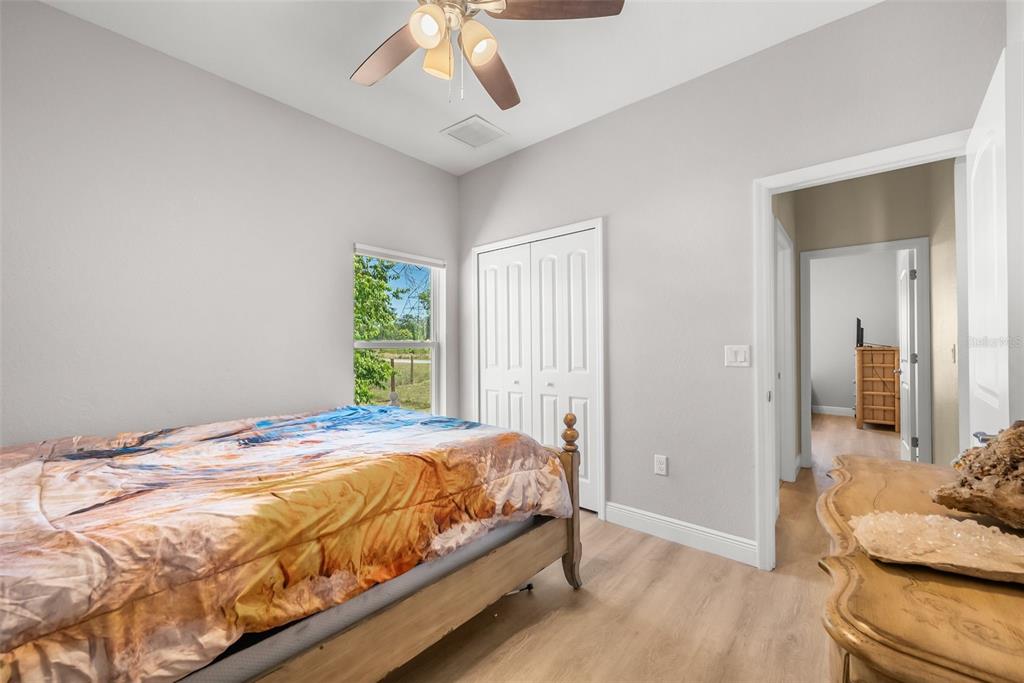 13391 Ruffed Grouse Road Weeki Wachee, FL 34614 - Photo 19 of 25 a bedroom with a bed and a chandelier