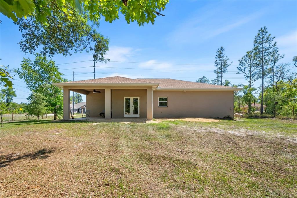13391 Ruffed Grouse Road Weeki Wachee, FL 34614 - Photo 23 of 25 a front view of house with yard and trees