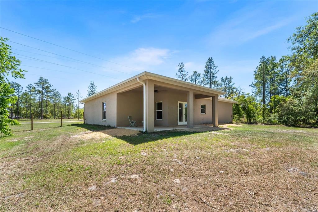 13391 Ruffed Grouse Road Weeki Wachee, FL 34614 - Photo 24 of 25 a house with trees in the background