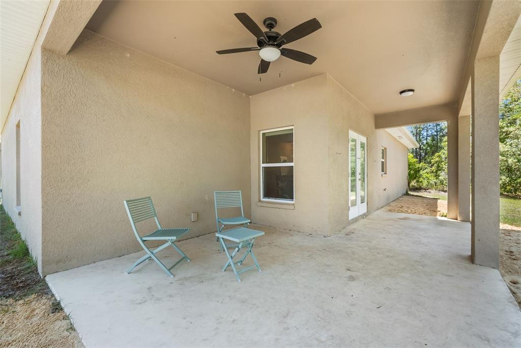 13391 Ruffed Grouse Road Weeki Wachee, FL 34614 - Photo 25 of 25 a view of a livingroom with chair and a ceiling fan