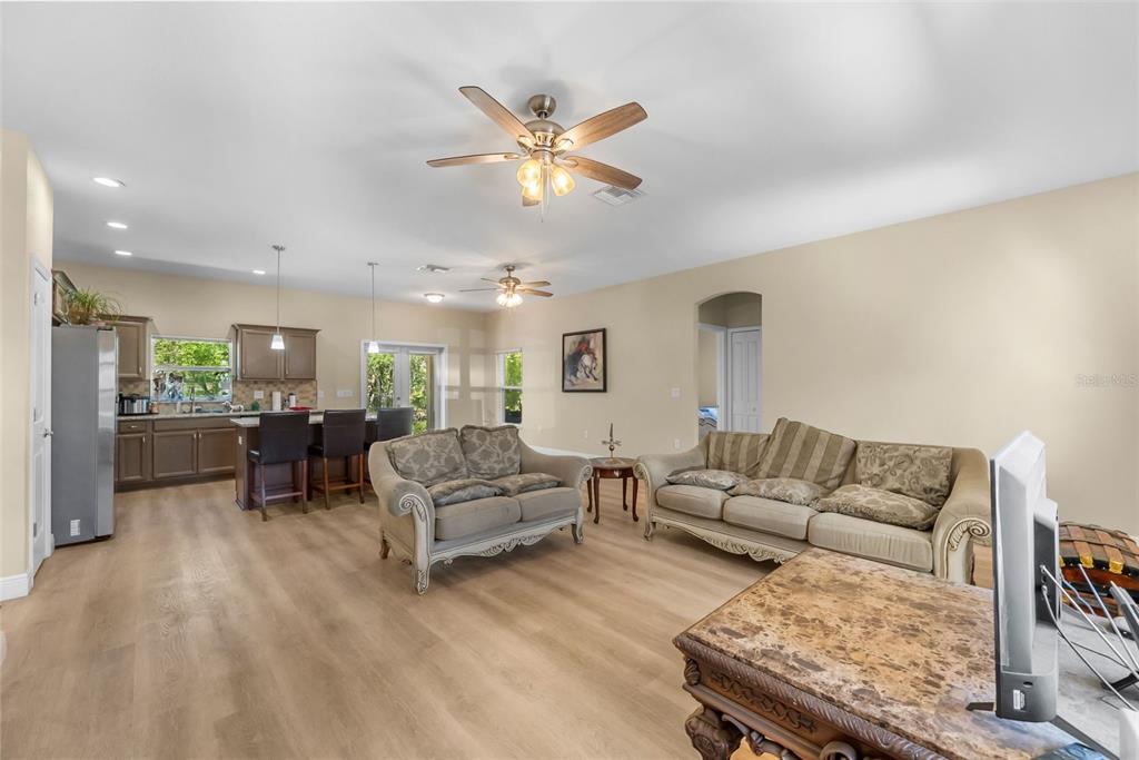 13391 Ruffed Grouse Road Weeki Wachee, FL 34614 - Photo 4 of 25 a living room with furniture and kitchen view
