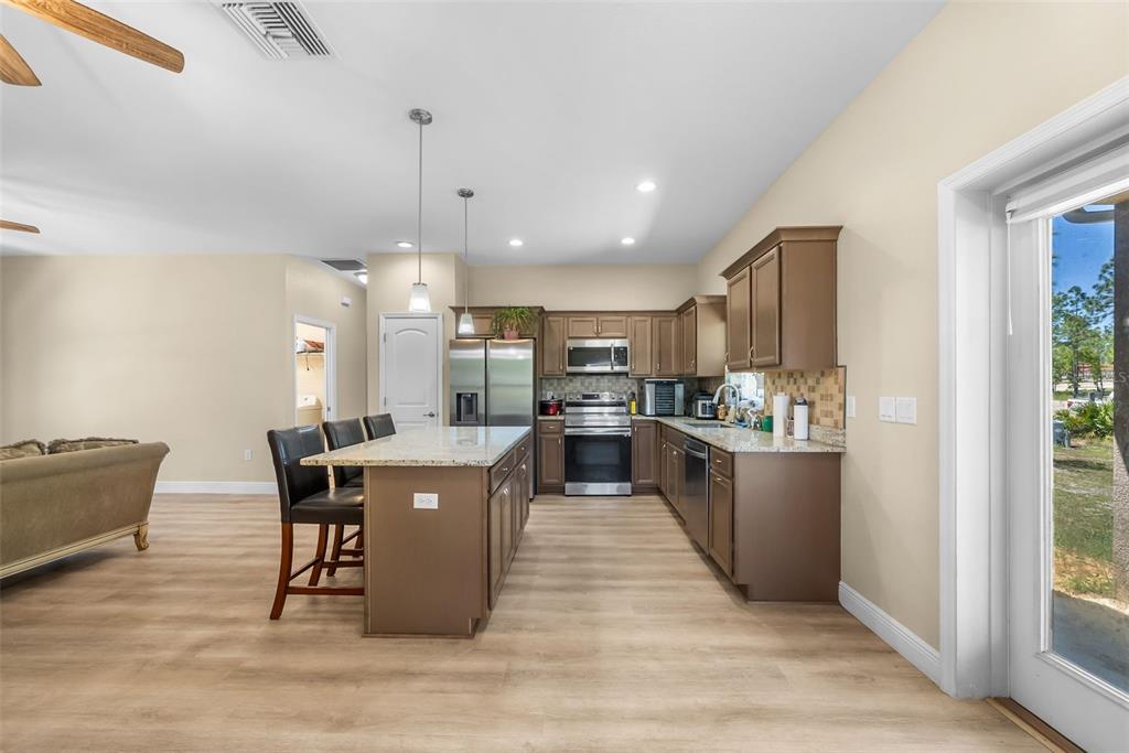 13391 Ruffed Grouse Road Weeki Wachee, FL 34614 - Photo 6 of 25 a large kitchen with a table and chairs