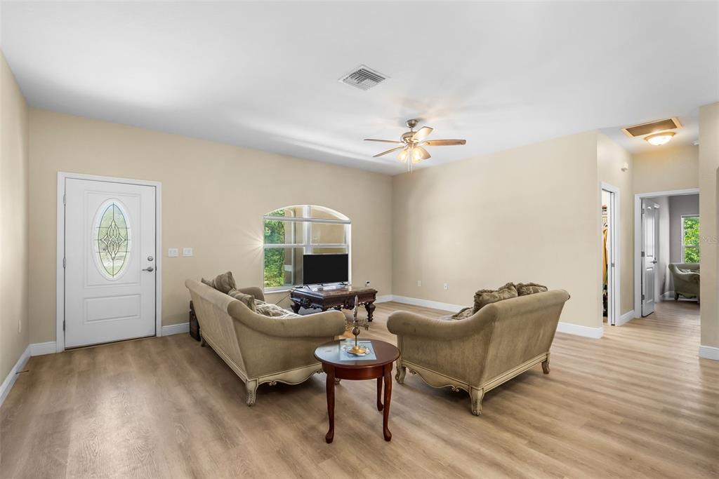 13391 Ruffed Grouse Road Weeki Wachee, FL 34614 - Photo 10 of 25 a living room with furniture and a wooden floor