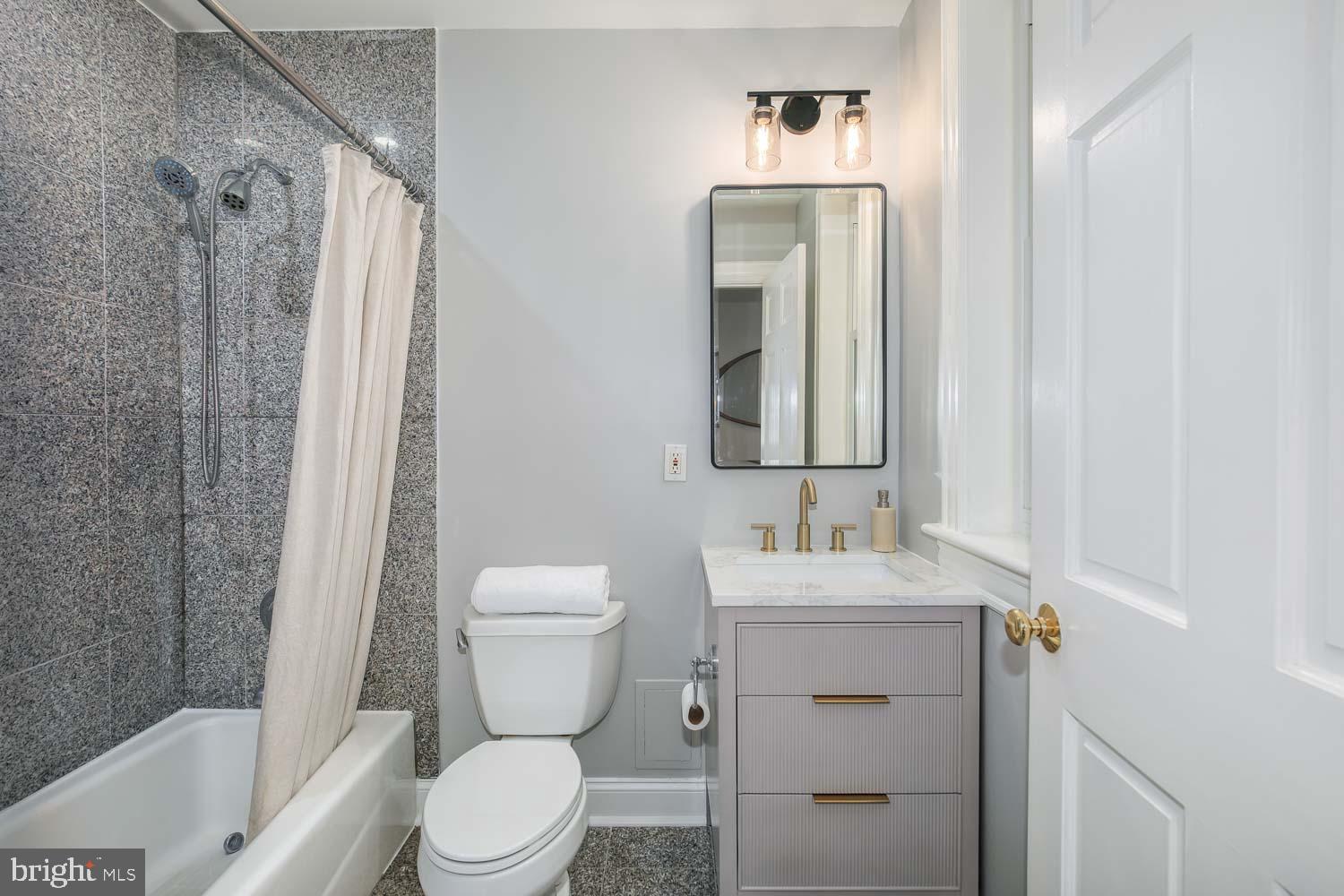 1212 M Street Northwest, Unit 401 Washington, DC 20005 - Photo 12 of 16 a bathroom with a sink vanity mirror and toilet