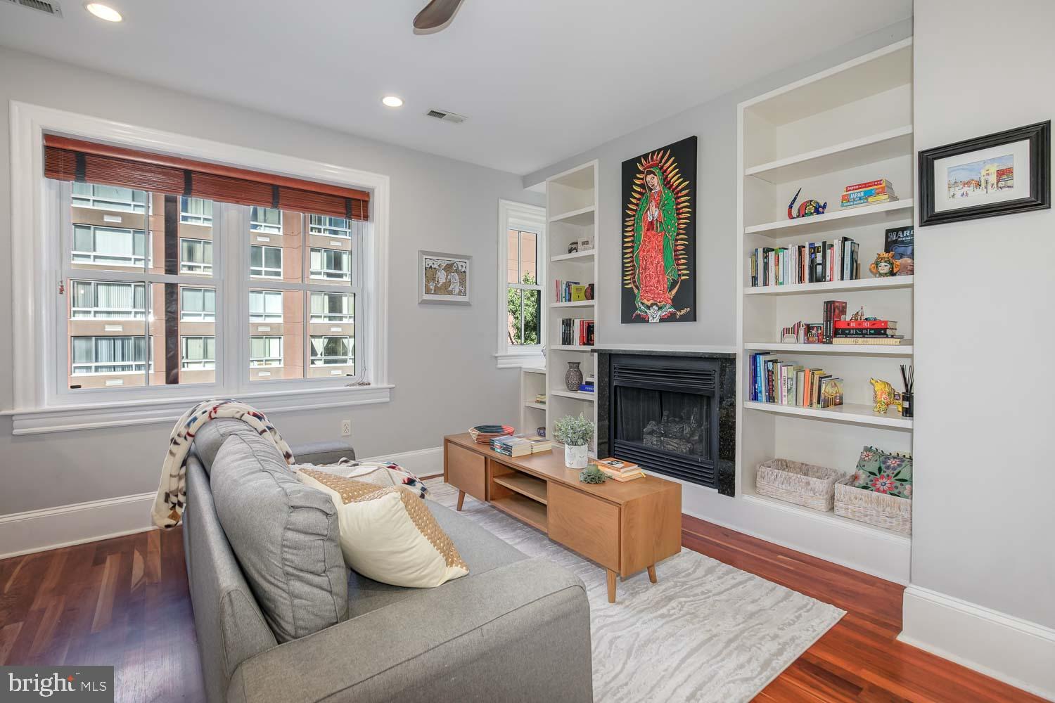 1212 M Street Northwest, Unit 401 Washington, DC 20005 - Photo 4 of 16 a living room with furniture and a fireplace