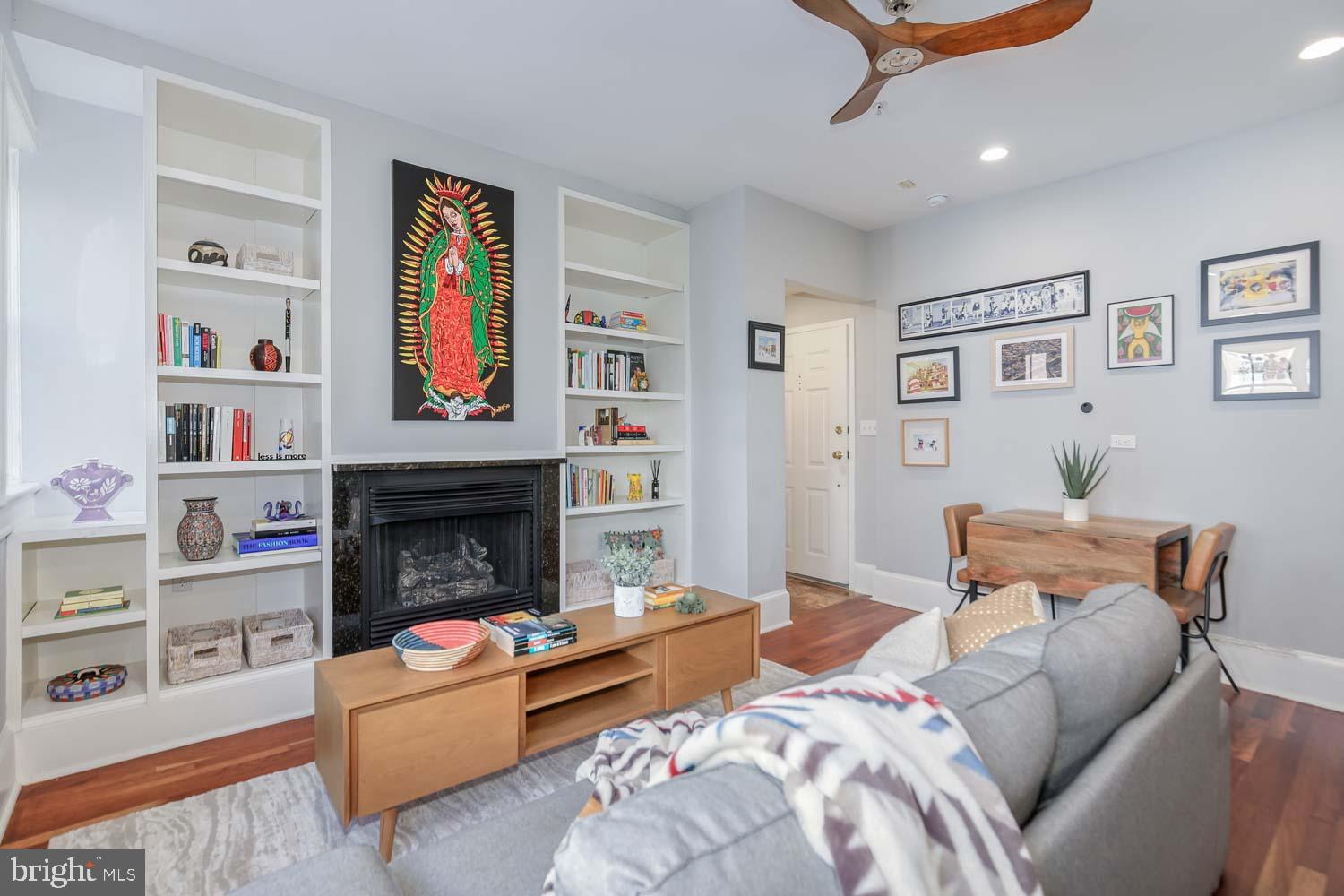 1212 M Street Northwest, Unit 401 Washington, DC 20005 - Photo 8 of 16 a bedroom with furniture and a fireplace