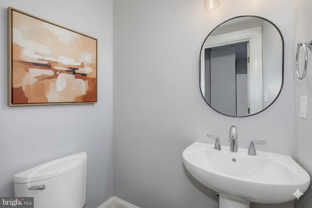 1212 M Street Northwest, Unit 401 Washington, DC 20005 - Photo 9 of 16 a bathroom with a toilet a sink and mirror