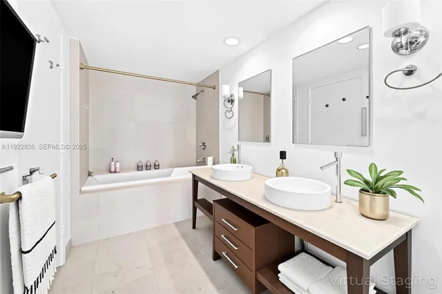 a spacious bathroom with a granite countertop sink a toilet a mirror and shower