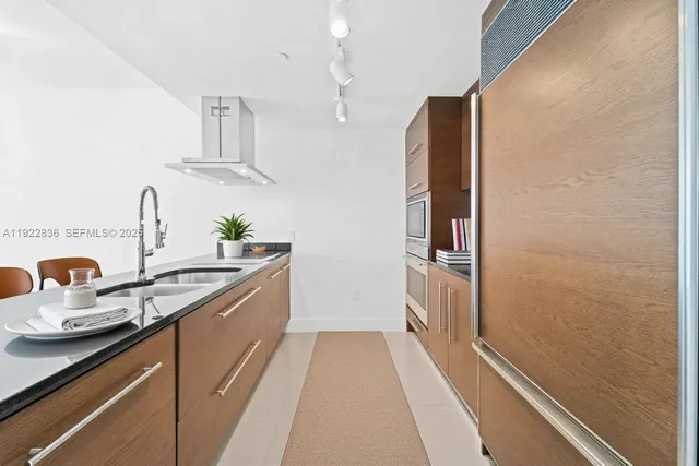a hallway with sink and mirror