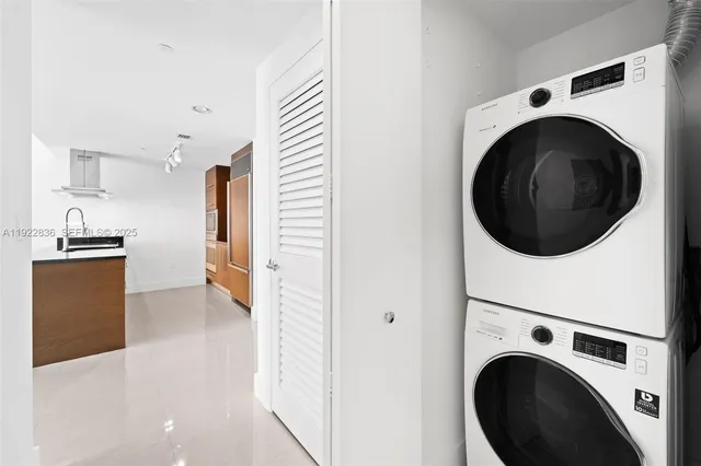 a view of a kitchen with a washer and dryer
