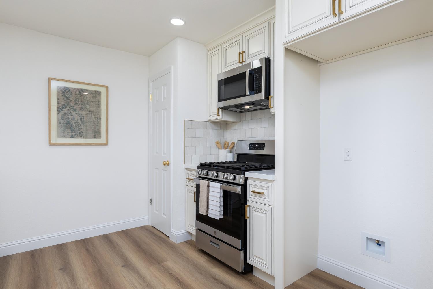 1185 East Evening Glow Circle Reedley, CA 93654 - Photo 13 of 42 a kitchen with a stove and a microwave