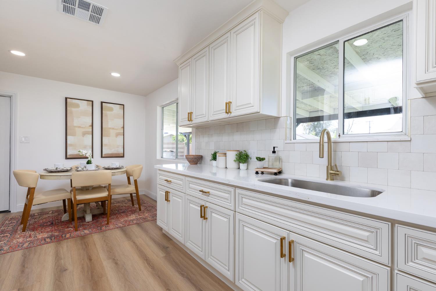 1185 East Evening Glow Circle Reedley, CA 93654 - Photo 17 of 42 a kitchen with sink cabinets and window