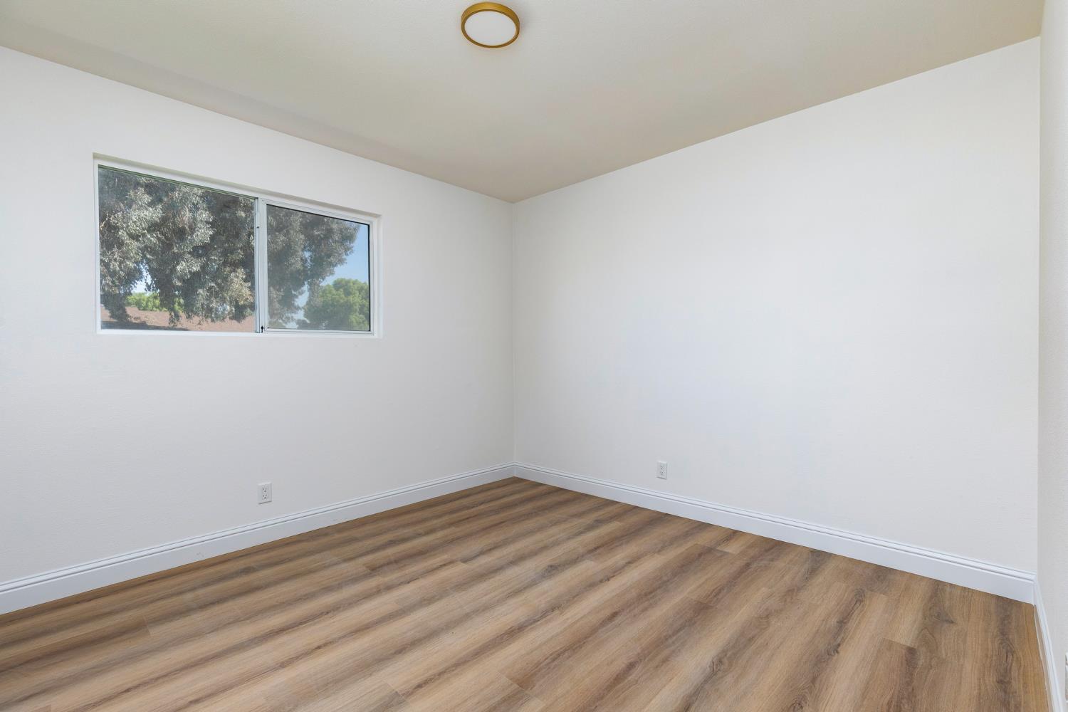 1185 East Evening Glow Circle Reedley, CA 93654 - Photo 22 of 42 an empty room with a window