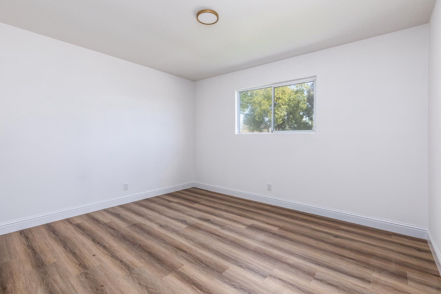 1185 East Evening Glow Circle Reedley, CA 93654 - Photo 26 of 42 a view of a room that has a window