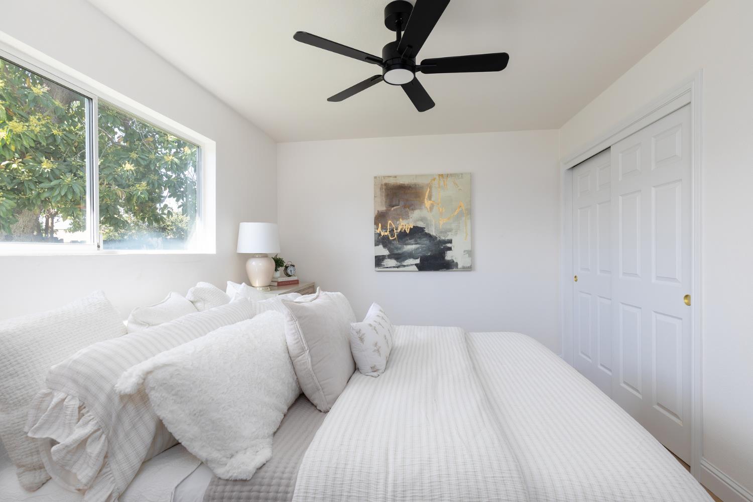 1185 East Evening Glow Circle Reedley, CA 93654 - Photo 29 of 42 a bedroom with a bed and a painting on the wall