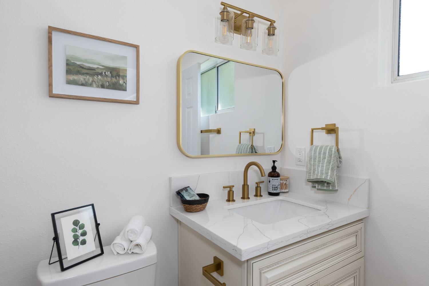 1185 East Evening Glow Circle Reedley, CA 93654 - Photo 33 of 42 a bathroom with a sink and a mirror