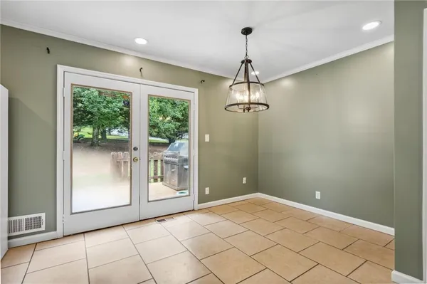 a view of an empty room with glass door