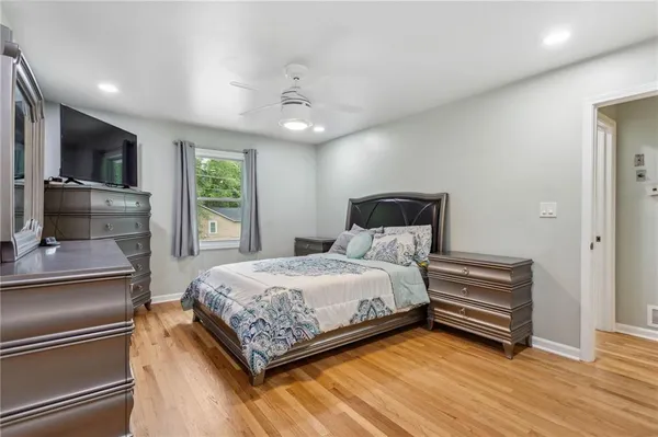 a bedroom with a bed and a television