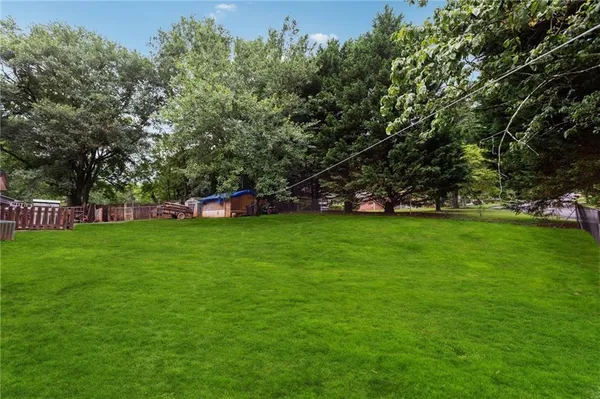 a view of field with trees in the background
