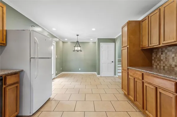 a view of a refrigerator in kitchen and wooden floor