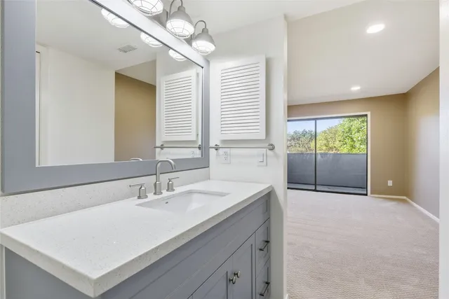 a bathroom with a sink a vanity and a mirror