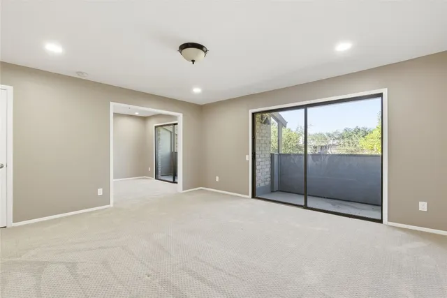 an empty room with sliding glass door and shower