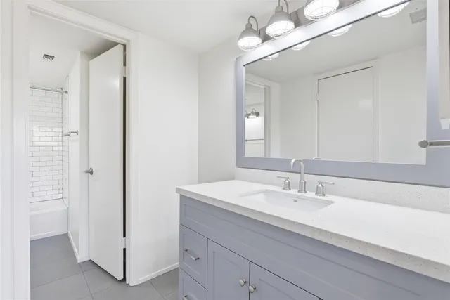 a bathroom with a sink double vanity and a mirror