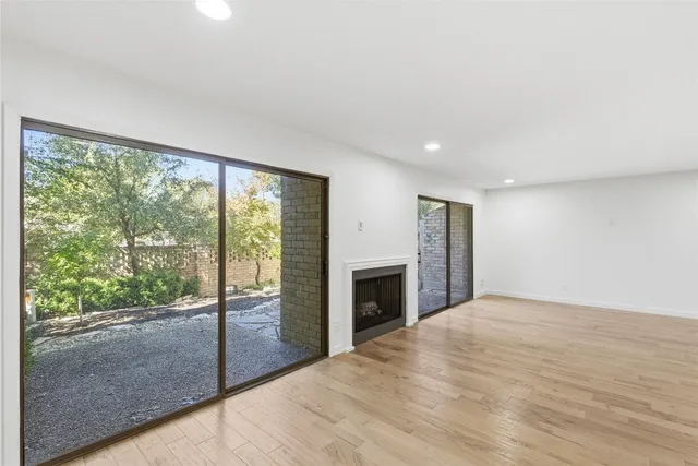 a view of empty room with floor to ceiling window and an entrance