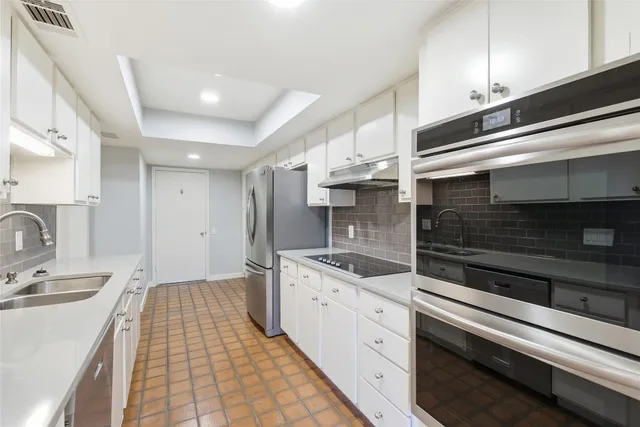 a kitchen with a sink stove and cabinets
