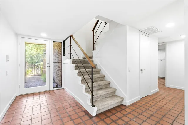 a view of entryway with wooden floor and stairs
