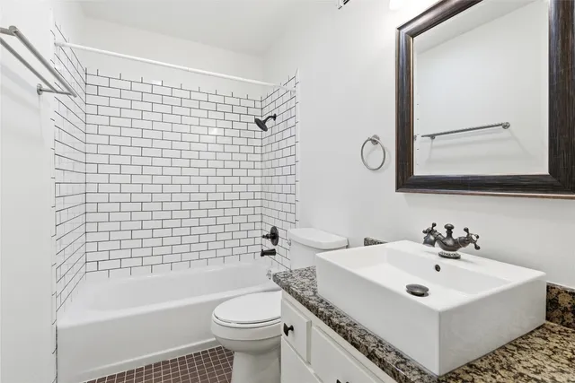 a bathroom with a sink a toilet and bathtub