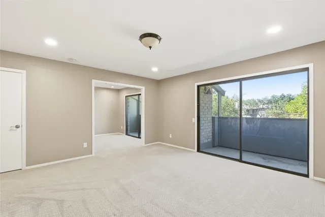 a view of an empty room with glass door