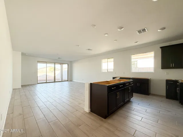 a kitchen with wooden floors and black appliances