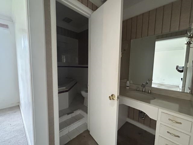 1917 Finley Road Memphis, TN 38116 - Photo 15 of 16 Bathroom featuring a vanity with integrated sink, a large mirror, and built-in storage drawers