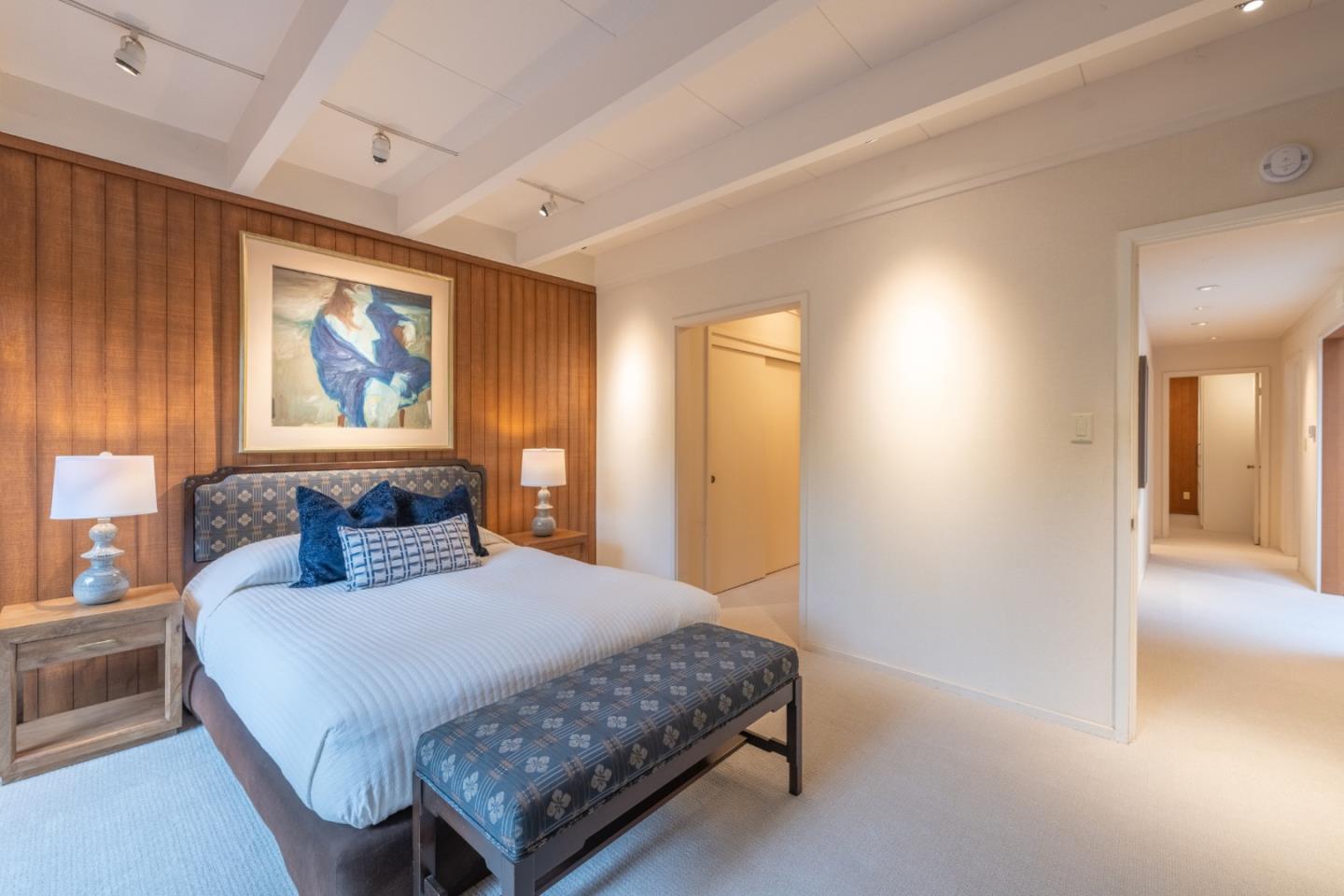 46 Middle Canyon Road Carmel Valley, CA 93924 - Photo 36 of 74 a bedroom with a large bed a painting on the wall and a large window