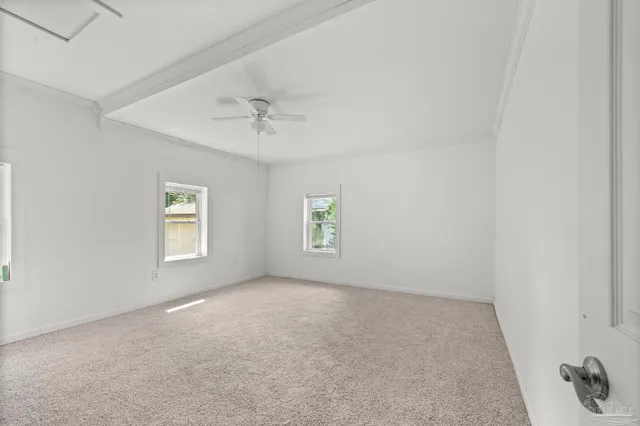 a kitchen with stainless steel appliances a refrigerator a sink and white cabinets
