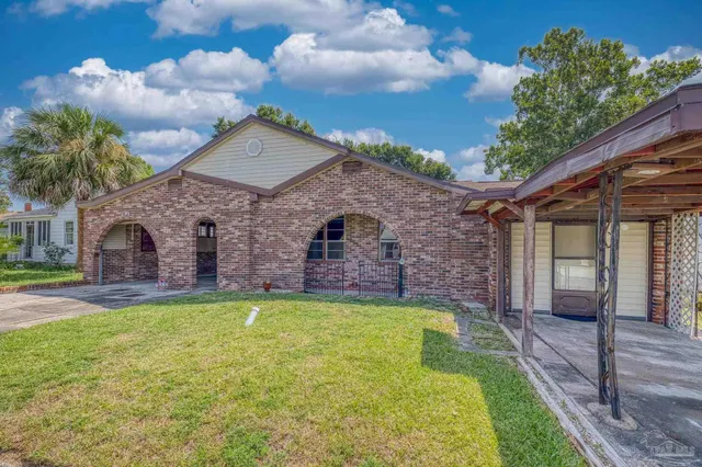 a view of a house with a swimming pool and a yard