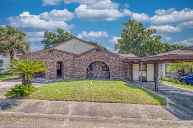 a view of a house with a yard and a garage