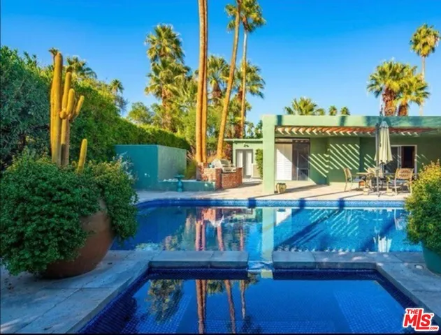 a view of a backyard with plants and a patio