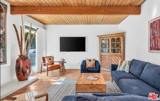 a living room with a table and a flat screen tv